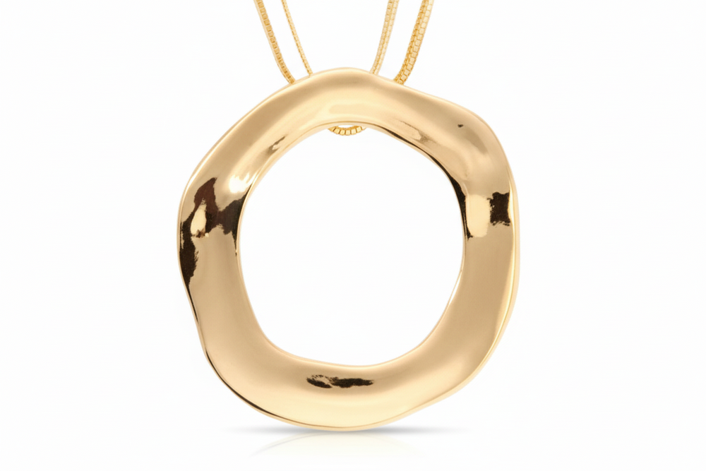 gold-colored open circle statement necklace with a ridged texture and two chains.