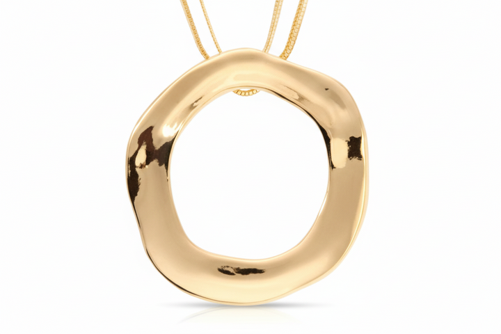 gold-colored open circle statement necklace with a ridged texture and two chains.